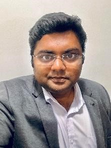 Antony Michaeline Praveen Maria, Senior Manager of Human Resources at Tata Consultancy Services seen posing for a photo in a grey color suit
